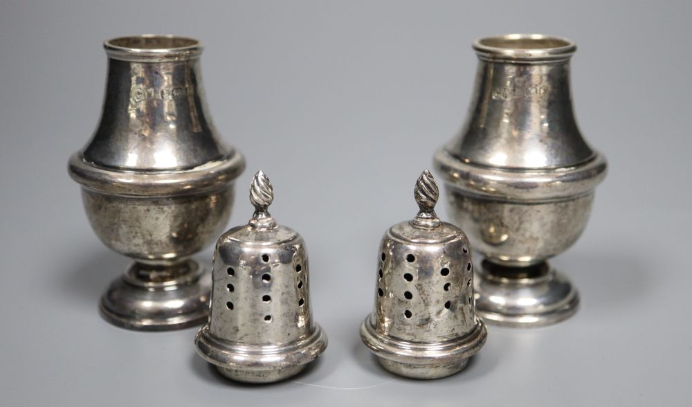 Four assorted 20th century silver casters, including a small pair, tallest 19.3cm, 11.5oz.